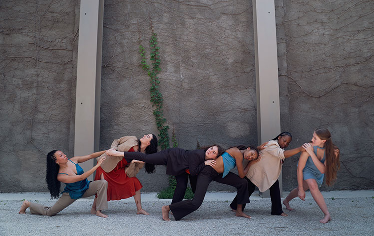 Verdant dancers pose with one another.