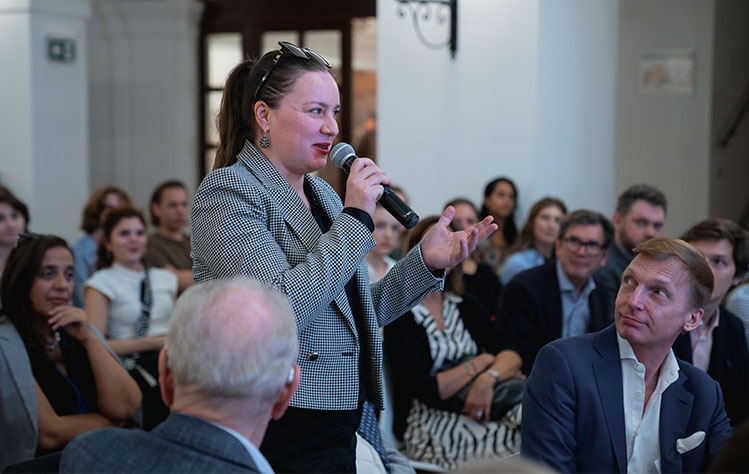 An attendee in the audience asks the panel a question.