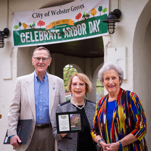 Chancellor Stroble and the Fogartys accept the award