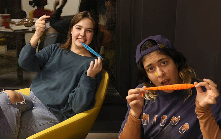 Two Webster 48 participants pose with this year’s selected prop: a worm on a string.