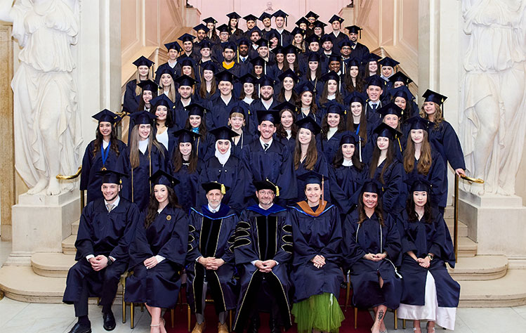 Webster Vienna Private University Class of 2024, seated for a group photo in graduation regalia.